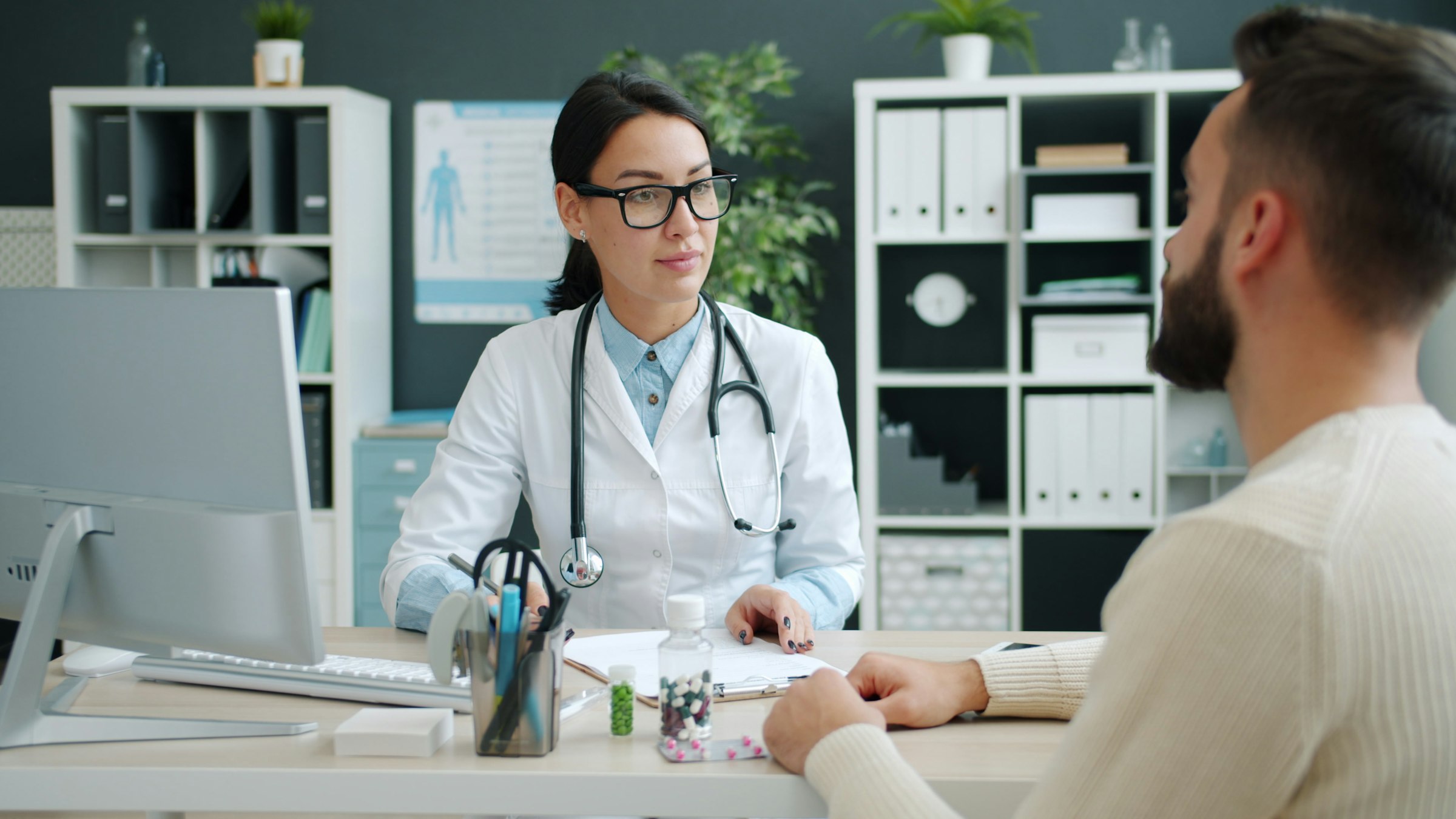 Physician consulting with a patient in a clinic office